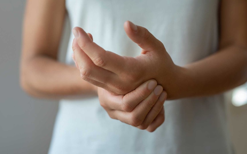 stock photo of person holding their hands in pain