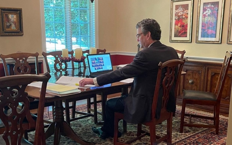 Attorney Doug Maynard sits at his dining room table preparing to argue before the NC Supreme Court on an auto insurance matter.