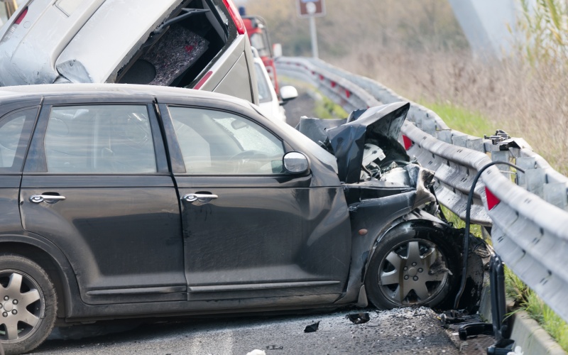 a car crashes on the side highway barrier