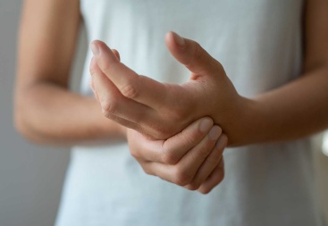 stock photo of person holding their hands in pain